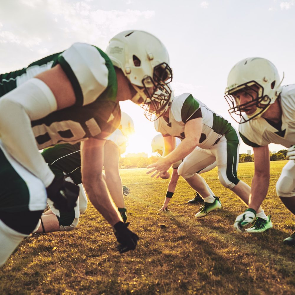 american-football-players-crouching-in-formation-during-a-team-practice.jpg